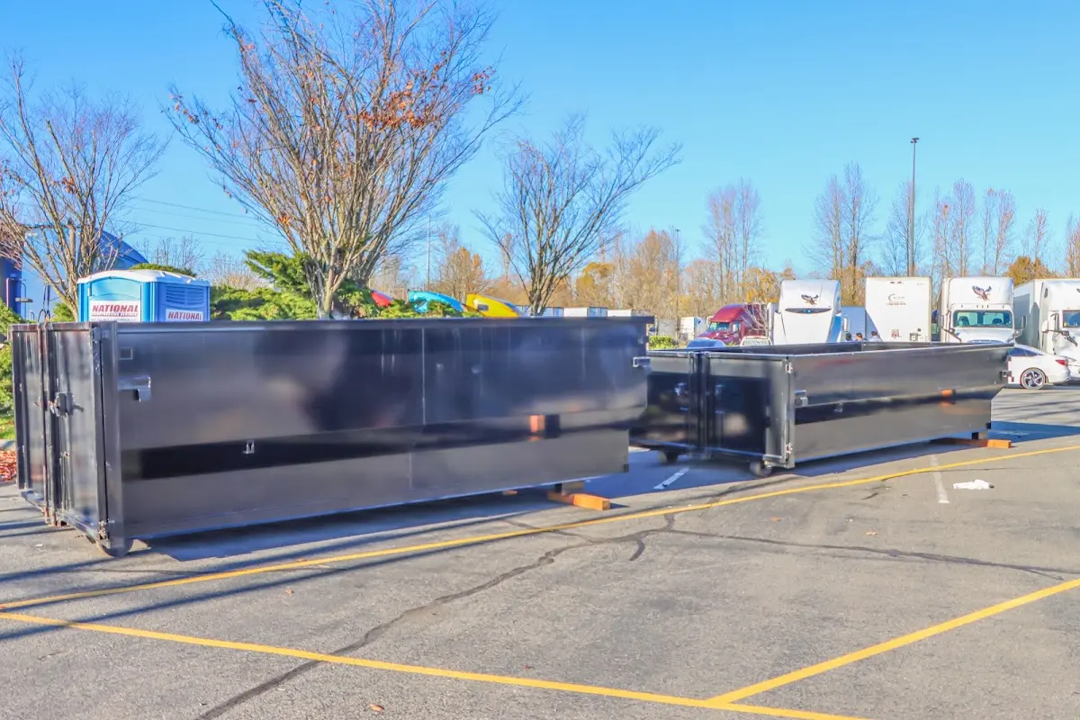 Professional dumpster rental service with roll-off container on residential driveway in Sandown